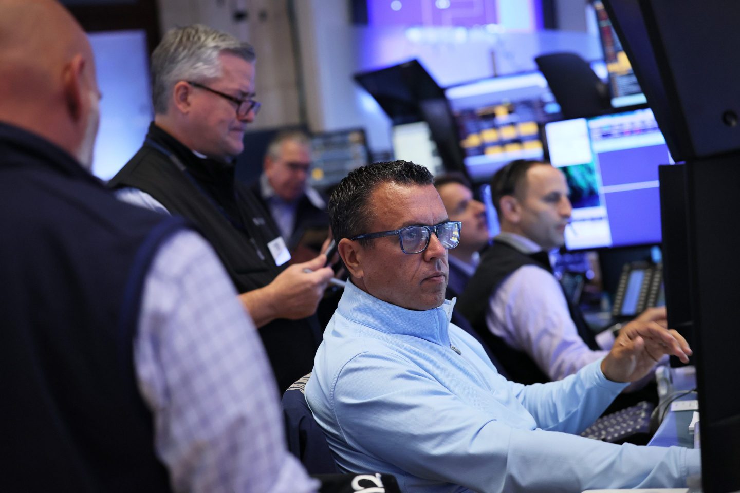 Wall Street traders reacting to major crypto ETF news on the trading floor in 2025
